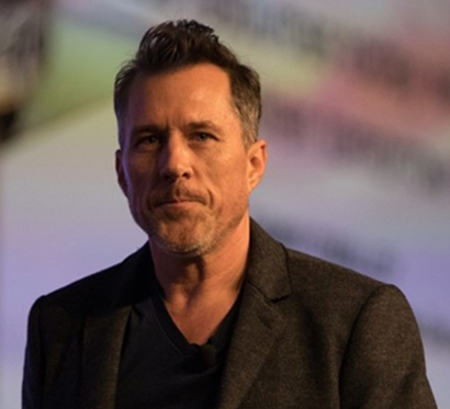 Danny O’Malley speaking on stage