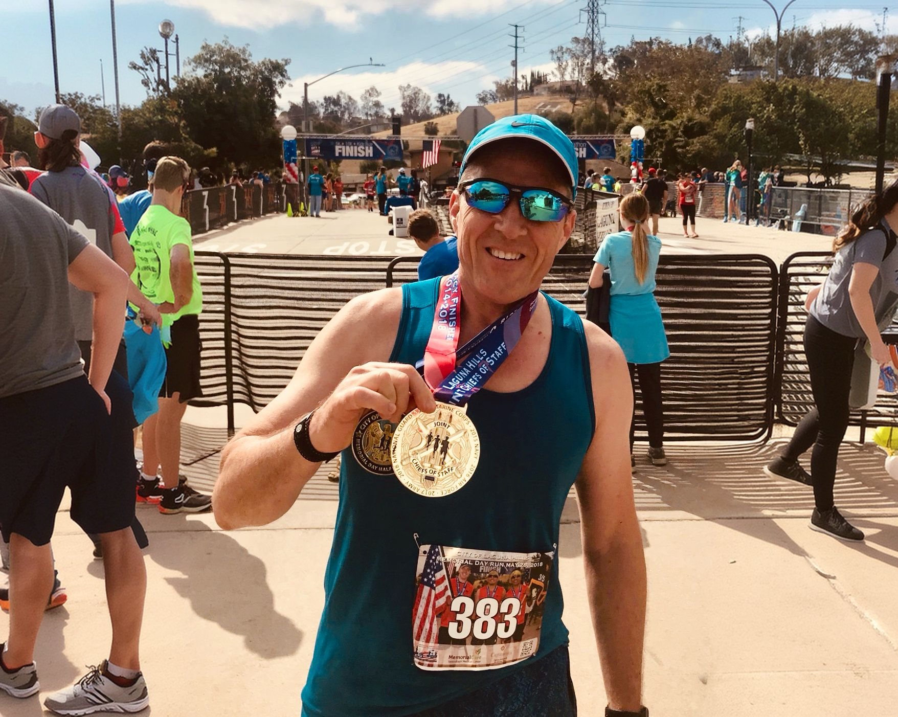 Danny O’Malley holding a marathon medal
